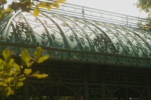a building with a glass roof and a metal fence